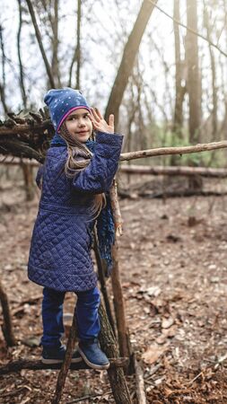 Young adventurer walking in the wild forest during her social distant life in lockdown time, walking on fresh air, outdoor active lifestyleの写真素材