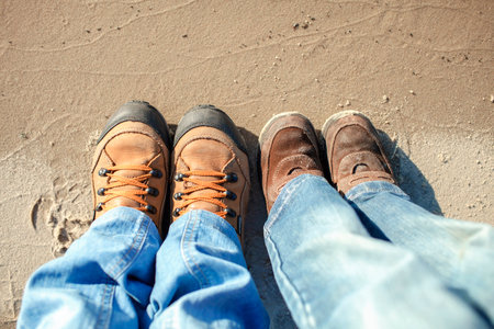 Family enjoying winter together, kids with parents walking on the beach in winter, cold temperature...