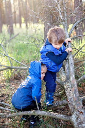 True men friendship, outing of crowed places, walking far from usual playground when lockdown is over. Two kids giving high five each other for greeting and support, outdoor summer lifestyleの写真素材