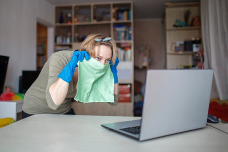 Young woman cleaning home, wiping dust and polishing tv screen and looking at self reflexing....