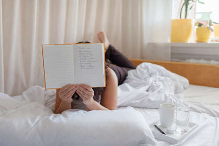 Mental health care, positive thinking and wellness concept. Attractive woman lying in bed,...