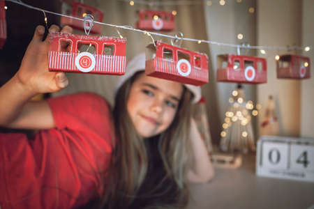 Happy kid dreams by original advent calendar on theme of skis and cable car. Ski resort funicular of rolls from toilette paper. Zero waste and reusable Christmas. Magic winter holiday, focus on cabinの写真素材