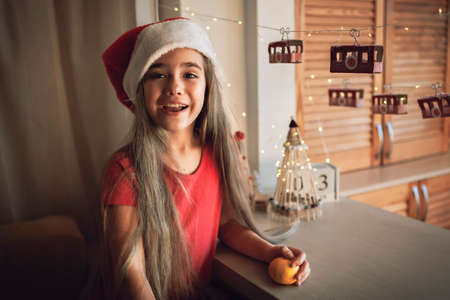 Happy kid plays with original advent calendar on theme of ski and cable car. Funicular advent calendar with toilette paper rolls. Zero waste and reusable Christmas. Magic winter holiday, focus on kidの写真素材