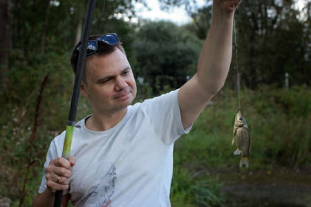 Portrait of adult man fishing with rods in early spring day, family weekend concept, outdoor