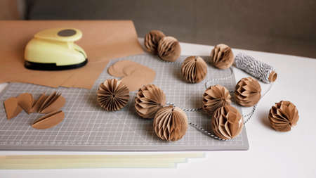 Craft Christmas paper decoration, tutorial. Making of festive garland with DIY honeycomb paper balls. Ecological and sustainable celebration. Seasonal activity with kids. Banner long formatの写真素材