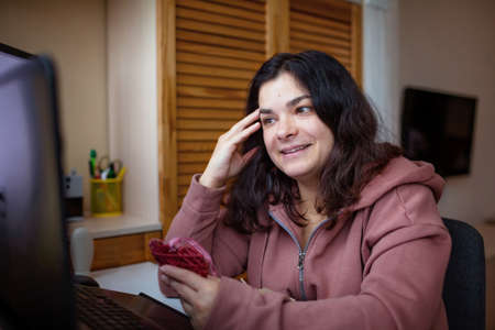 Woman chatting with her lover on the internet, they celebrate valentine day together online. Long distance relationship, social distance and new normal loveの写真素材