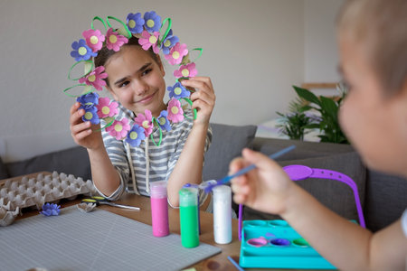 Transformation an ordinary egg carton into a beautiful Easter flower wreath. Kids show the creative and sustainable possibilities of Zero Waste lifestyle. Reduce, reuse, and recycle. DIY with kidsの写真素材