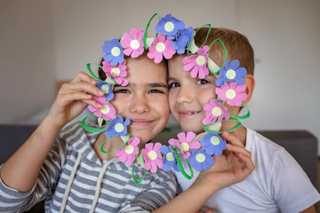 Transformation an ordinary egg carton into a beautiful Easter flower wreath. Kids show the creative and sustainable possibilities of Zero Waste lifestyle. Reduce, reuse, and recycle. DIY with kidsの写真素材