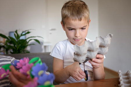 DIY project with kids, an egg carton is transformed into Easter flower wreath. Creativity and sustainability that come with a Zero Waste lifestyle. Reduce, reuse, and recycleの写真素材