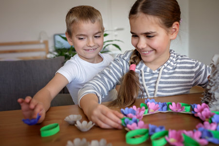 DIY project with kids, an egg carton is transformed into Easter flower wreath. Creativity and sustainability that come with a Zero Waste lifestyle. Reduce, reuse, and recycleの写真素材