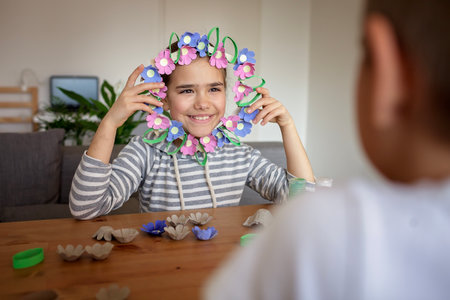 DIY project with kids, an egg carton is transformed into Easter flower wreath. Creativity and sustainability that come with a Zero Waste lifestyle. Reduce, reuse, and recycleの写真素材