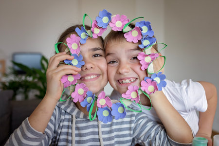 Transformation an ordinary egg carton into a beautiful Easter flower wreath. Kids show the creative and sustainable possibilities of Zero Waste lifestyle. Reduce, reuse, and recycle. DIY with kidsの写真素材