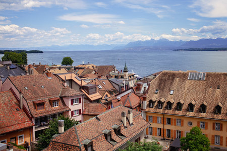 Panoramic view of Nyon terracotta rooftops with Lake Geneva and the Alps in the distance, embodying tranquility.の写真素材