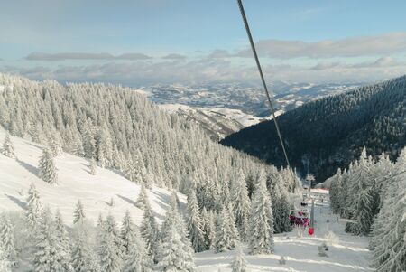 Ski lift on mountains with cloudsの写真素材