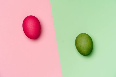 pink and green eggs on matching backgroundsの写真素材