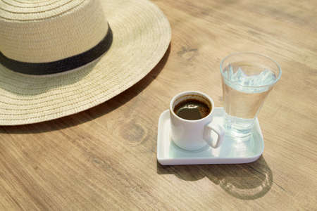 Summer hat, black Turkish coffee and glass of waterの写真素材