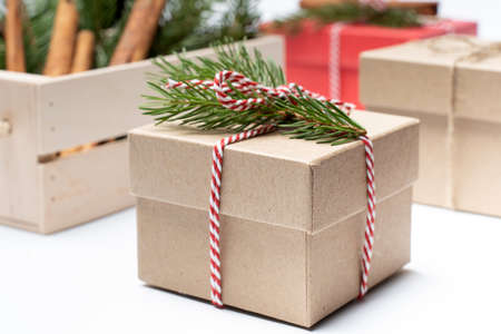 craft box with pine tree branch, white and red rope holidays boxes backgroundの写真素材