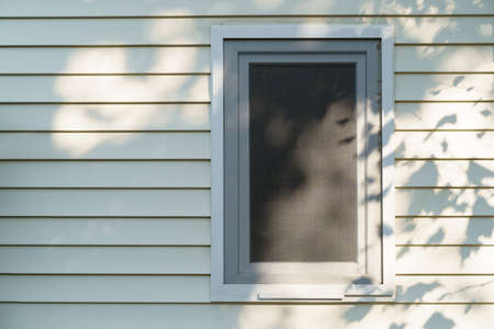 Tiny mobile house wall and window with shadow from the tree. High quality photo