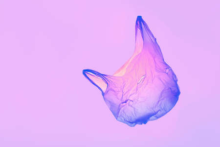 Transparent pink violet plastic bag in violet toned light. High quality photoの写真素材