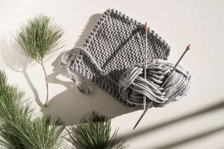 Knitting peace and rope on white table and fir tree natural light. Hobby concept. High quality photoの写真素材
