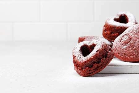 Heart form cupcakes, red velvet muffins with powdered sugar. Valentine's day concept and ideaの写真素材