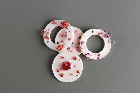 Aroma sachets with dried flowers with coconut or organic soy wax. flat lay on gray background