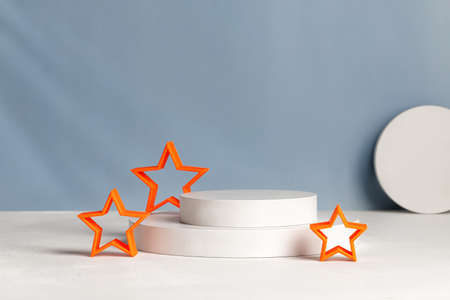 Podiums with orange stars for presentation and cosmetic. natural beauty pedestal in sunlight. Shadow...