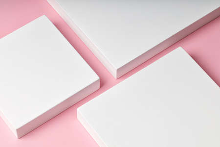 White square podiums for presentation and cosmetic. Beauty pedestal on pink backgrond, copy space
