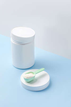 Jar and measure spoon with collagen or protein powder. Skin care beauty supplement. copy spaceの写真素材