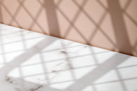 Display scene with window shadow. Mock up. Minimal background for product presentation. Beige and marble background. front diagonal view.の写真素材