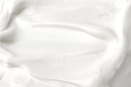 White Yogurt mousse texture. ice cream background. Tasty liquid texture of sour cream. Creamy dairy product background. Yogurt waves of white mousse. close up, macroの写真素材