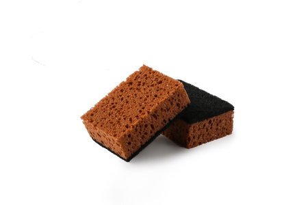 Two brown Kitchen Dishwashing Sponges for washing dishes isolated on white background, cut out. Cleaning home concept.の写真素材