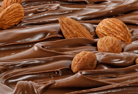 Chocolate cream with almond nuts. Sauce, paste, syrup. Background of liquid chocolate. curl. Texture, Close up, front view. close upの写真素材