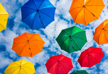 Colorful umbrellas in blue skyの写真素材