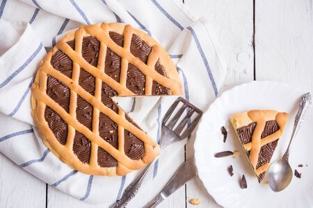 Delicious homemade chocolate cake on white wooden backgroundの写真素材