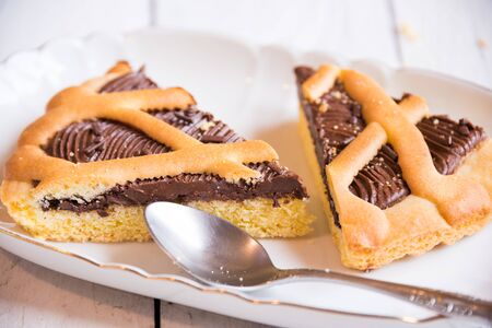 Delicious homemade chocolate cake on white wooden backgroundの写真素材