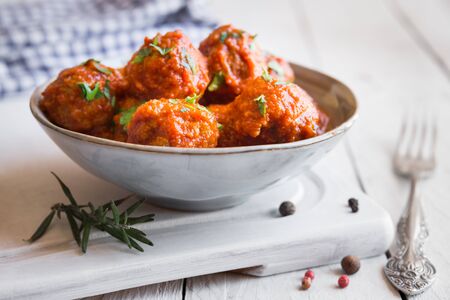 Homemade meatballs with tomato sauce and parsley in a bowlの写真素材