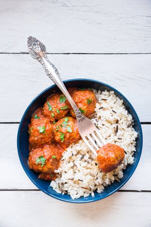 Homemade meatballs withrice on woodの写真素材