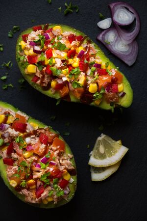 Avocado filled with tuna fish and vegetablesの写真素材