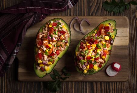 Avocado filled with tuna fish and vegetablesの写真素材