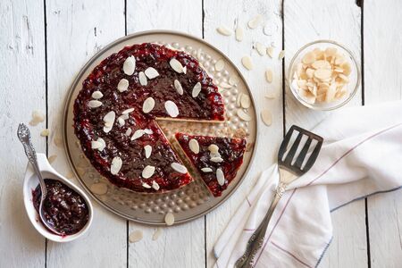 Homemade cheesecake with fruit jam and almonds
