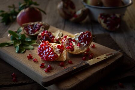 Fresh organic pomegranate with leaves on dark backgroundの写真素材