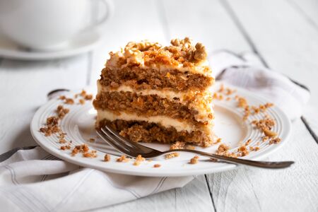 Slice of cake. Carrots and walnuts cake with creamy cheese