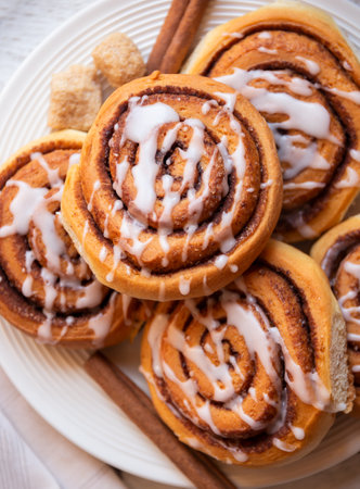 Fresh home baked sweet cinnamon buns with frostingの写真素材