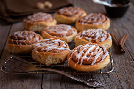 Fresh home baked sweet cinnamon buns with frostingの写真素材