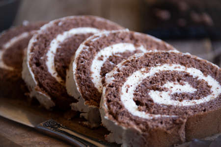 Delicious chocolate roll cake with white cream, homemade baked dessert