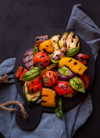 Grilled mixed vegetables, cooked peppers, zucchini, tomatoes and onions. Healthy vegetarian foodの写真素材