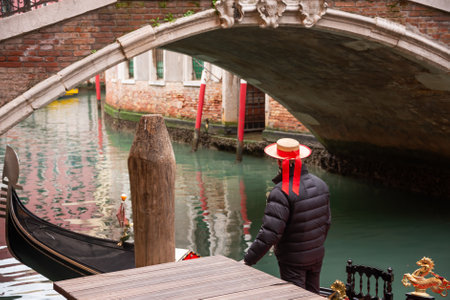 Gondolier in Venice with traditional hatの写真素材