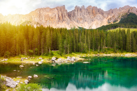 Carezza lake surrounded by forest and mountains in Dolomite alps, Italyの写真素材