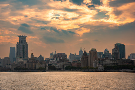 Shanghai city skyline seen from water at sunset, China